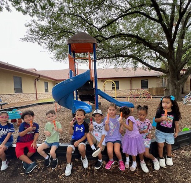 Students wearing team shirts and enjoying ice pops