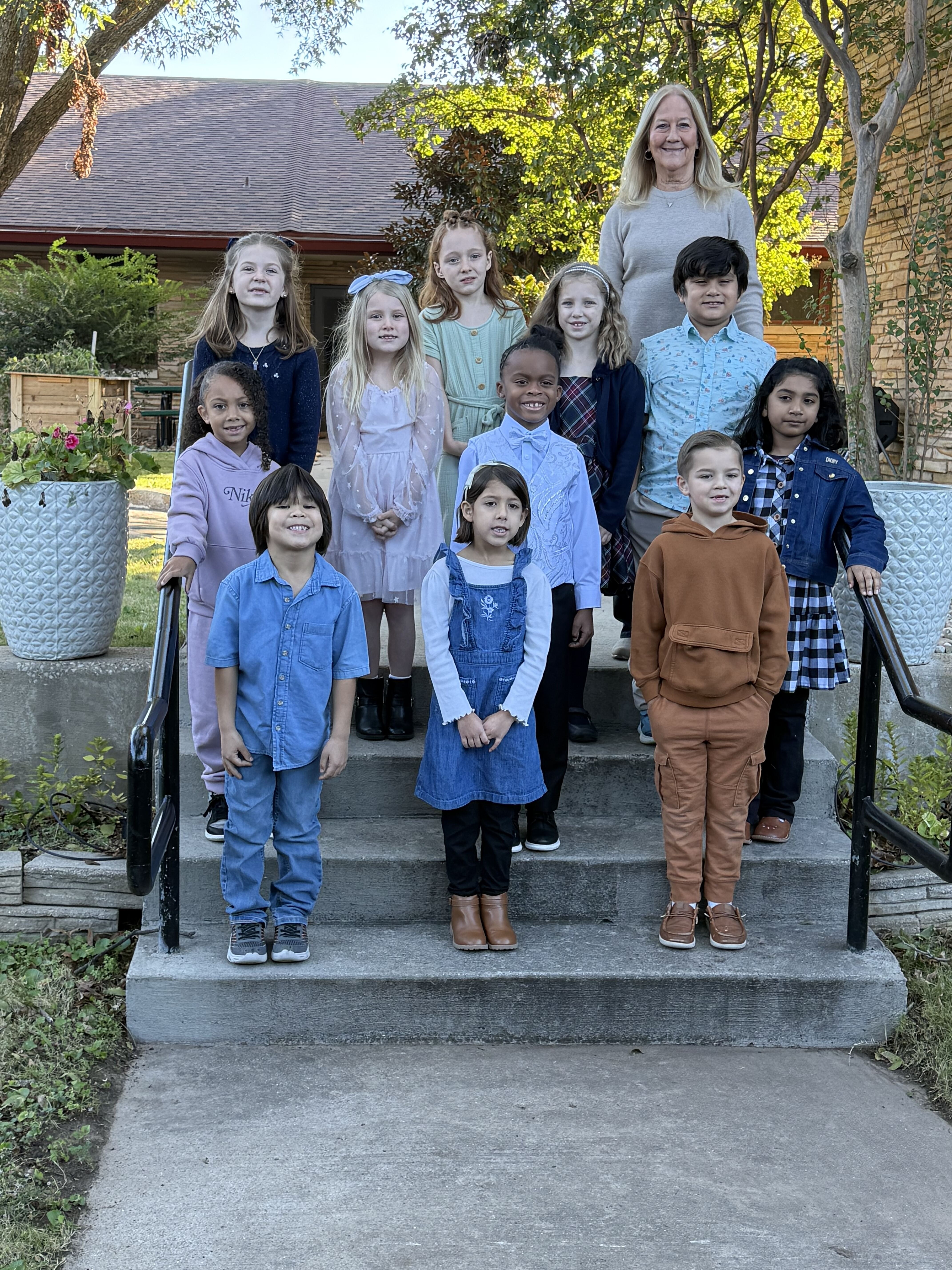 First through Third Grade students with teacher outdoors